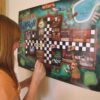 Sebastian Sharp and Elise Sharp Misterioso Manor Practice Motivation Game with Student Moving on Giant Game Board