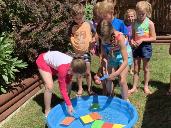 Students at Summer Splash Music and Piano Camp Identifying Treble Clef Notes in Pool